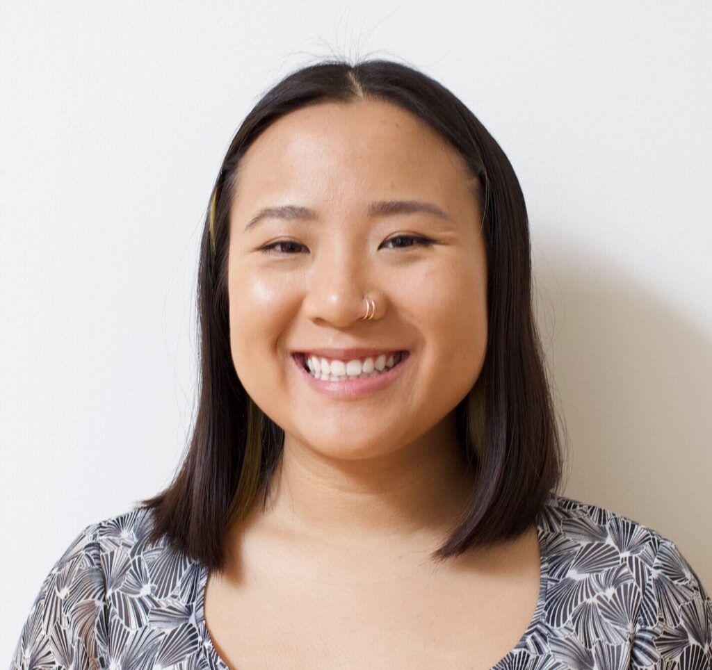 Nati Phan's headshot. She is a young Asian woman wearing a black-and-white shirt, with a white wall behind her. She is smiling at the camera.